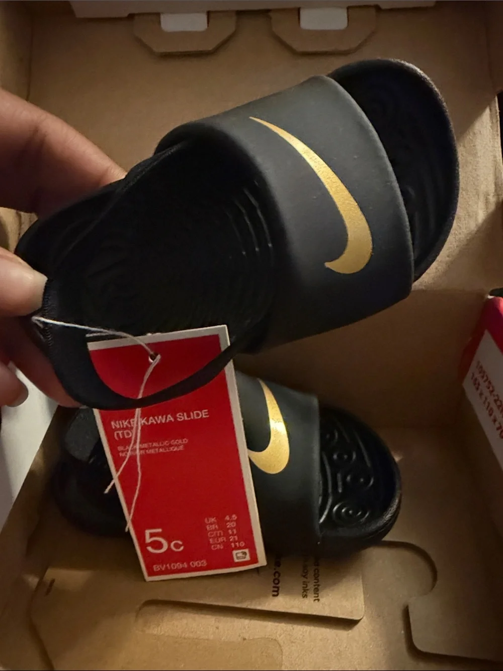 Nike Kids Black Slides with Metallic Gold Swoosh